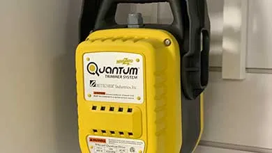 Close-up of a yellow and black Zetcher Industries Quantum Trimmer System, wall-mounted.