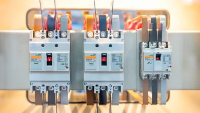 Tall telecommunications tower with multiple antenna dishes overlooking a coastal city