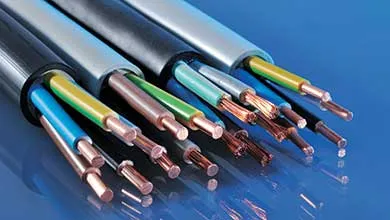 Close-up of several black and gray electrical cables on a reflective blue surface. The cable ends are stripped, showing colorful insulated wires and exposed copper conductors.